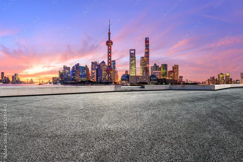 Shanghai skyline and modern buildings with empty race track at sunrise,China.