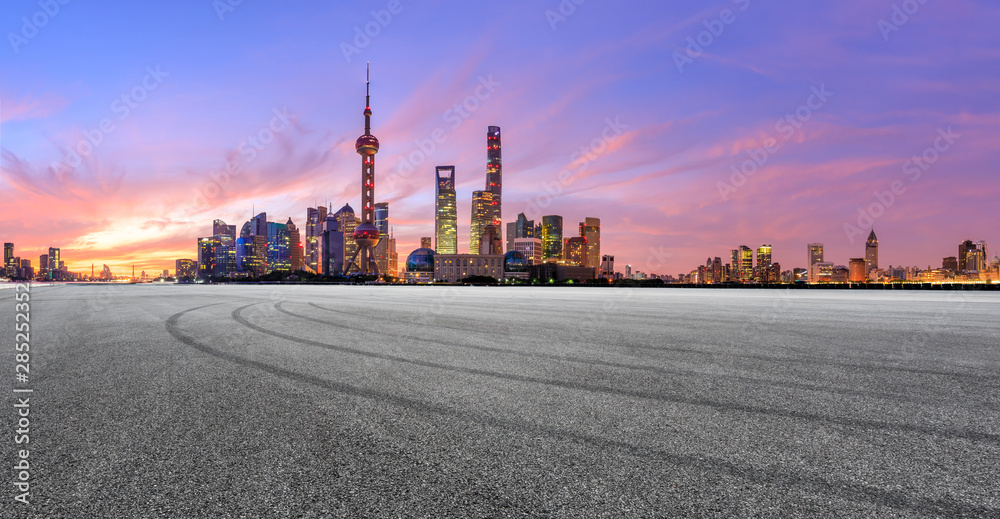 Shanghai skyline and modern buildings with empty race track at sunrise,panoramic view.