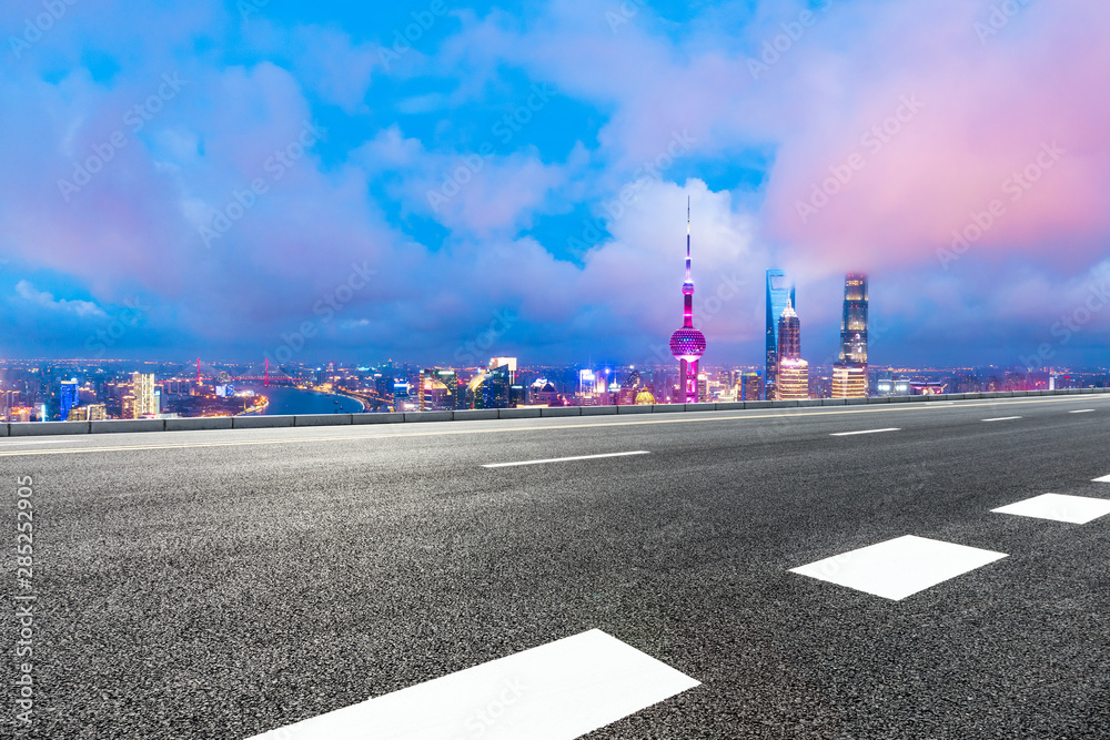 Shanghai skyline and modern buildings with empty highway at night,high angle view