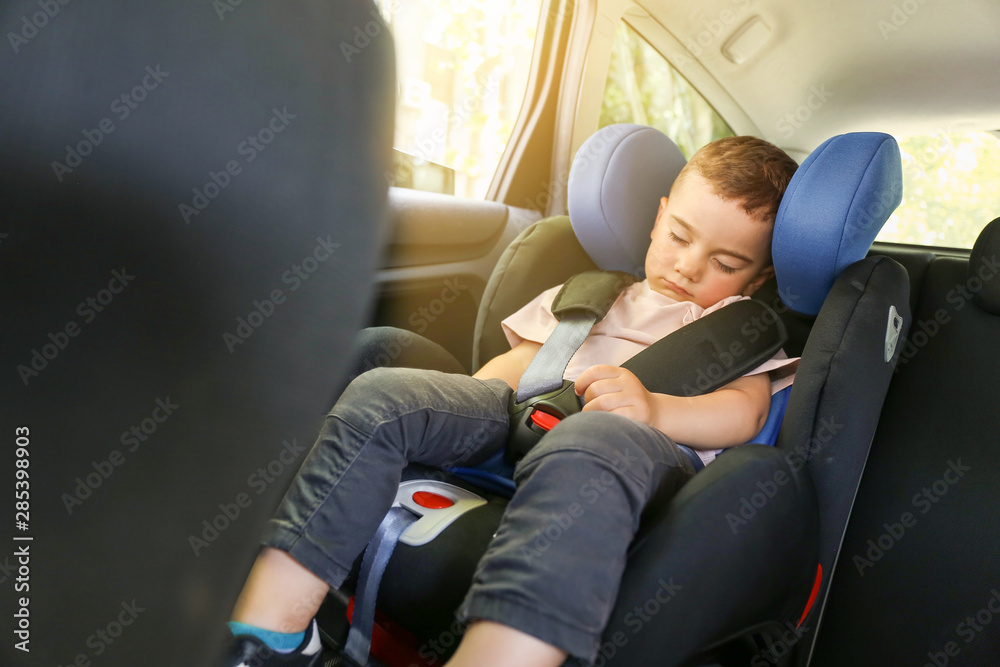 Sleeping baby boy buckled in car seat