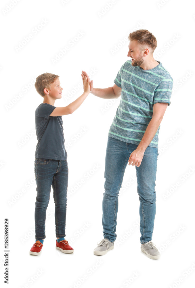 Father and son giving each other high-five on white background