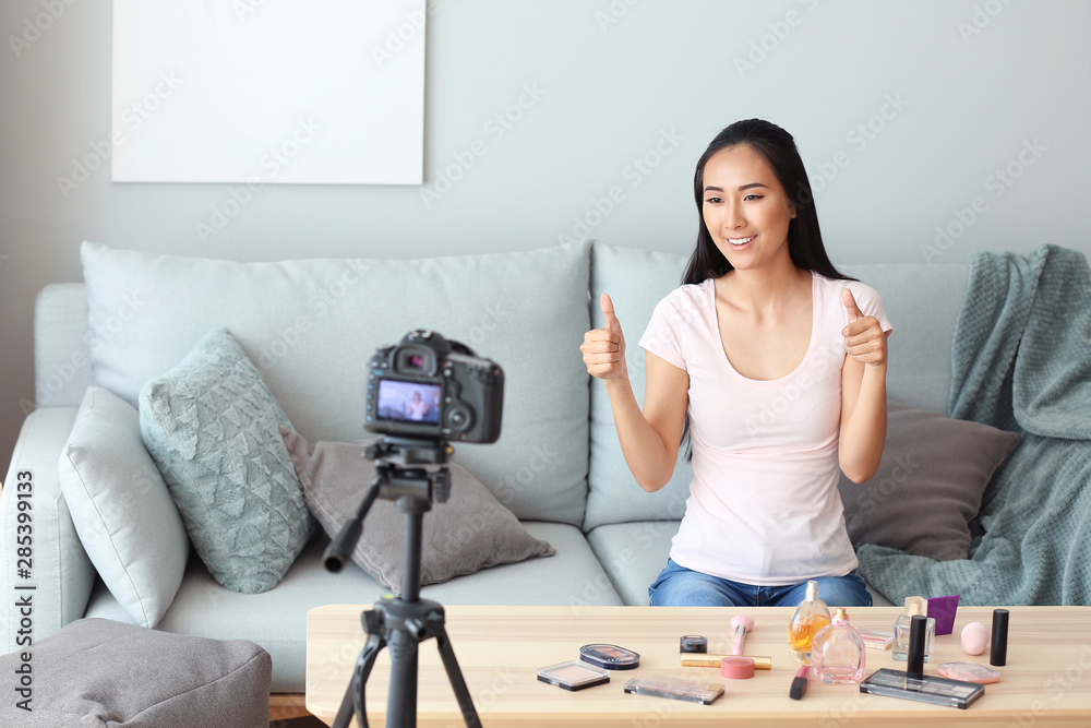 Asian beauty blogger recording video at home