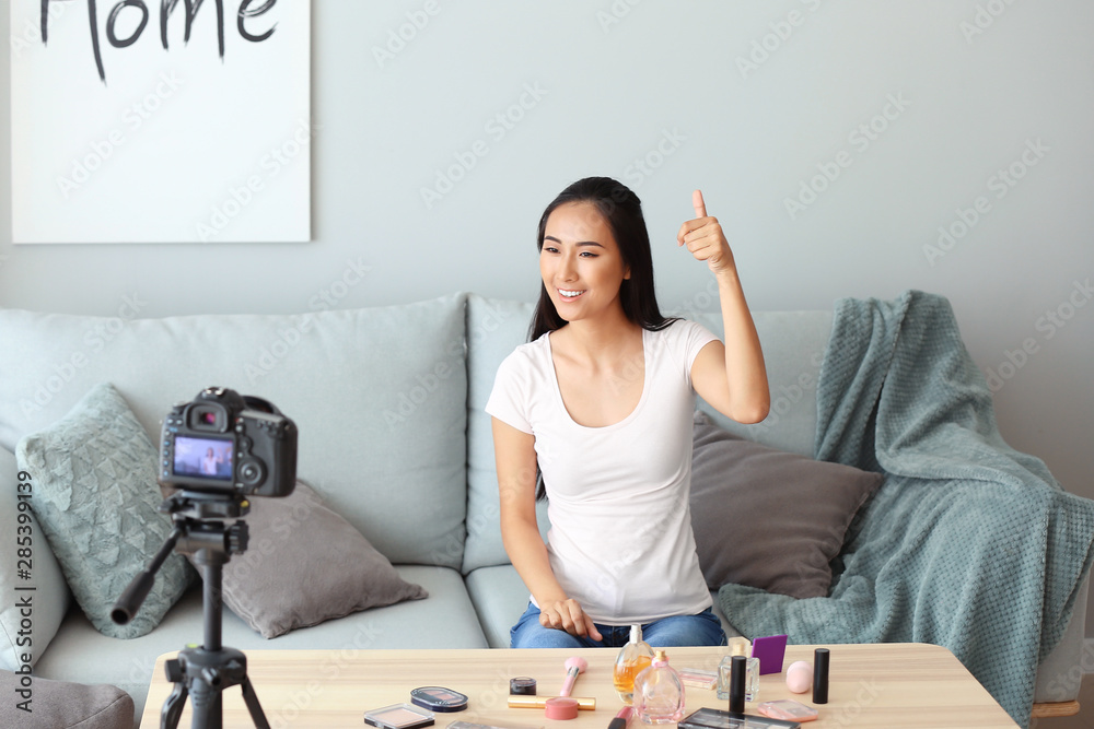 Asian beauty blogger recording video at home