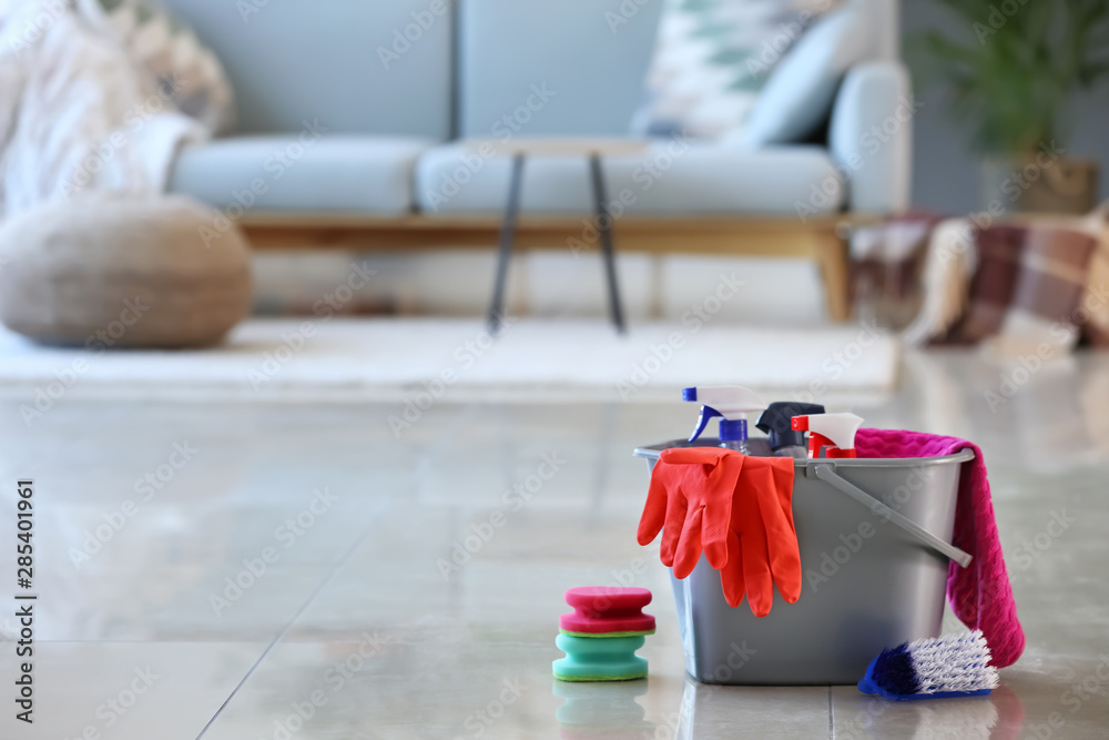 Set of cleaning supplies on floor in room