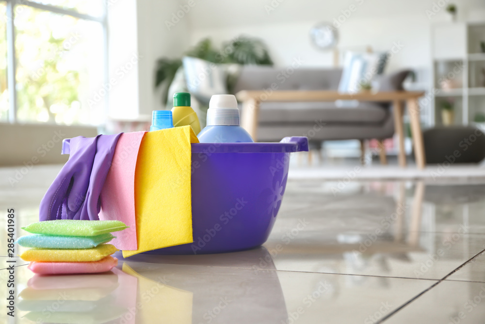 Set of cleaning supplies on floor in room