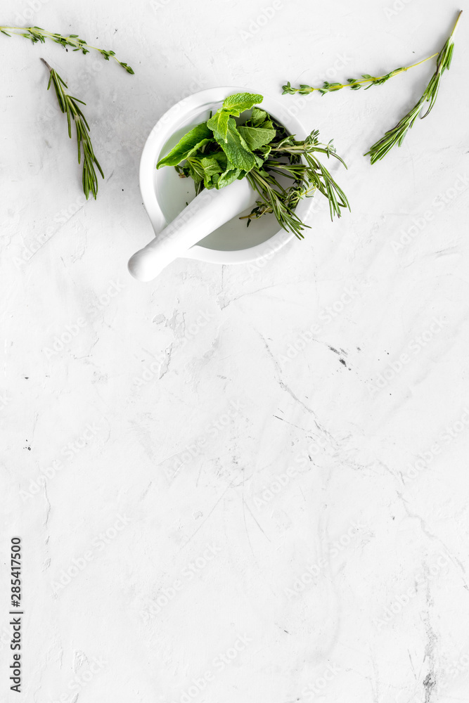 Alternative medicine with medicinal herbs on white marble background top view mock up