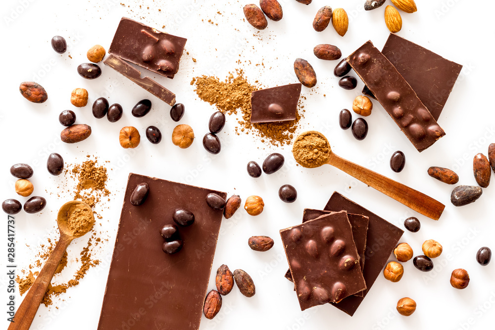 Cook homemade chocolate with bars, nuts, coffee beans on white background top view