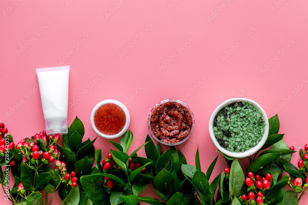 homemade spa with cosmetic from herbs and berrries on pink background top view space for text