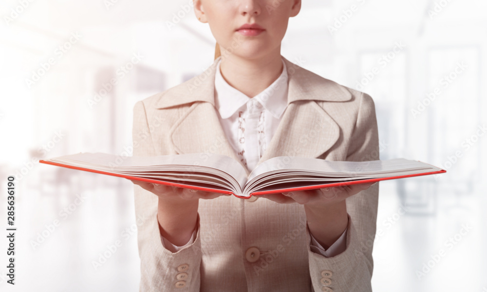 Businesswoman holding open notebook