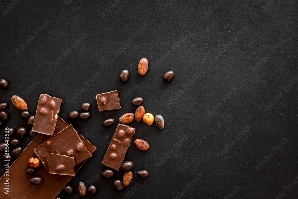 Cook homemade chocolate with bars, nuts, coffee beans on black background top view mock up