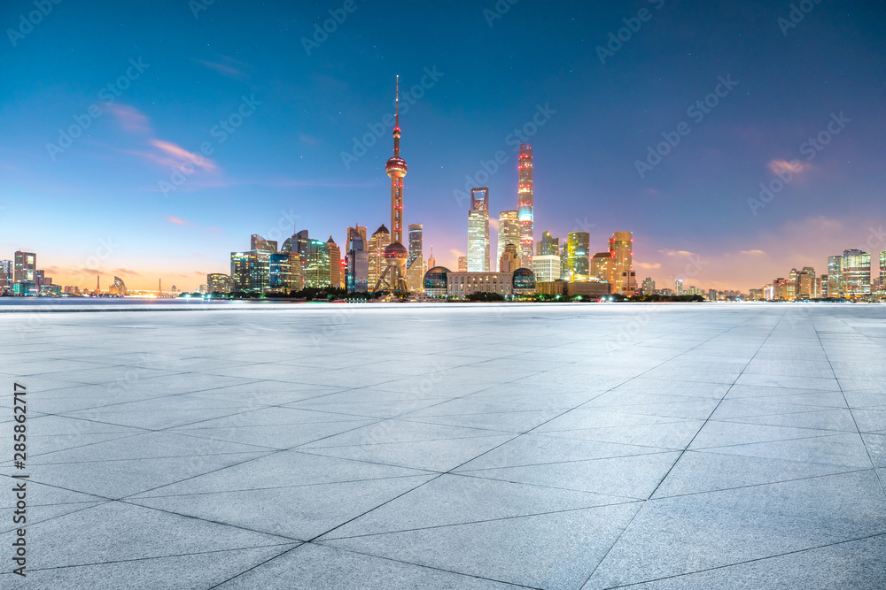 Empty square floor and modern city scenery at night in Shanghai,China.