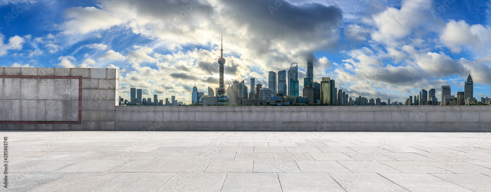 Empty square floor and modern city scenery at sunrise in Shanghai,China.