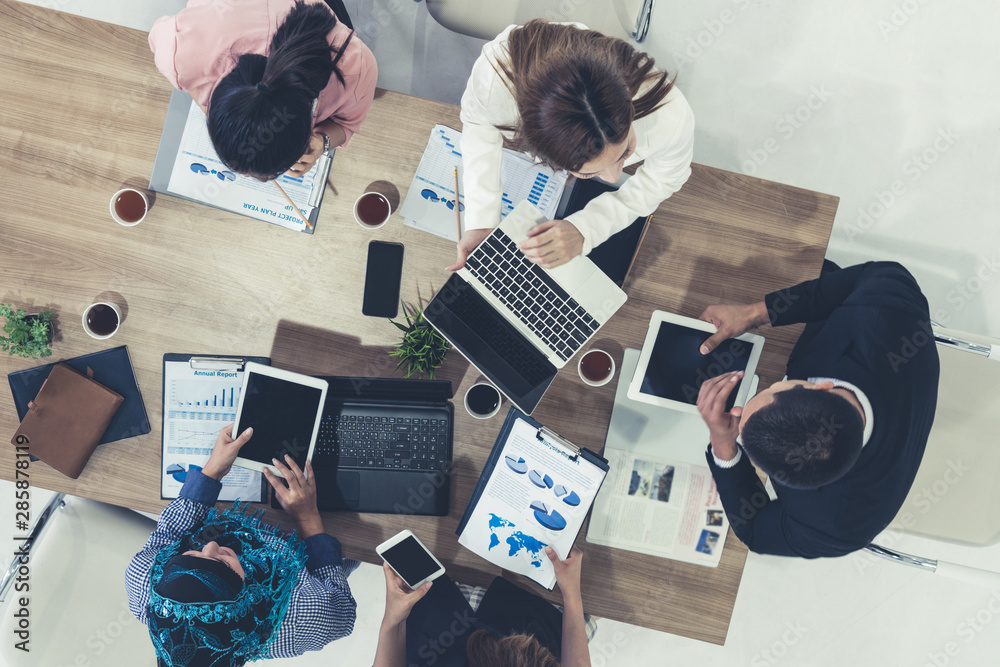 Top view of businessman executive in group meeting with other businessmen and businesswomen in moder