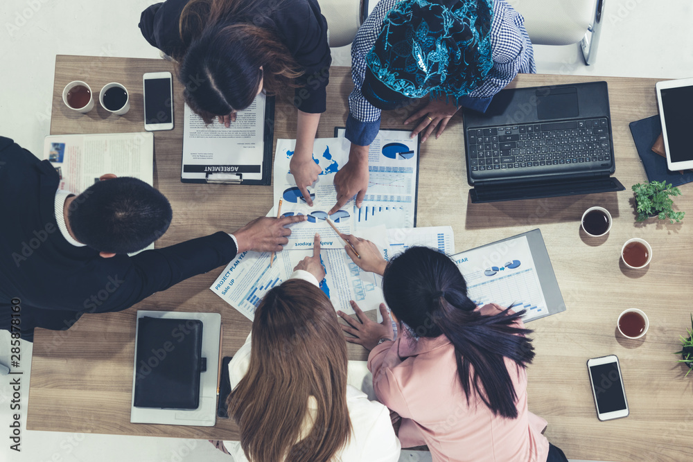 Top view of businessman executive in group meeting with other businessmen and businesswomen in moder