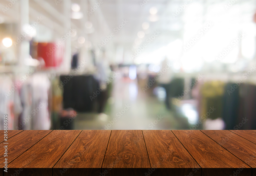 Wood table in shopping mall or department store blur background with empty copy space on the table f