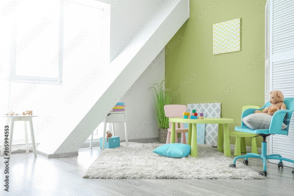 Stylish interior of modern playroom in kindergarten