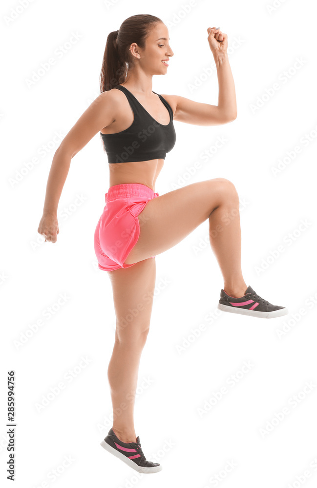 Jumping sporty woman on white background