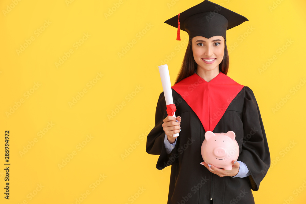 Female graduate with diploma and piggy bank on color background. Tuition fees concept