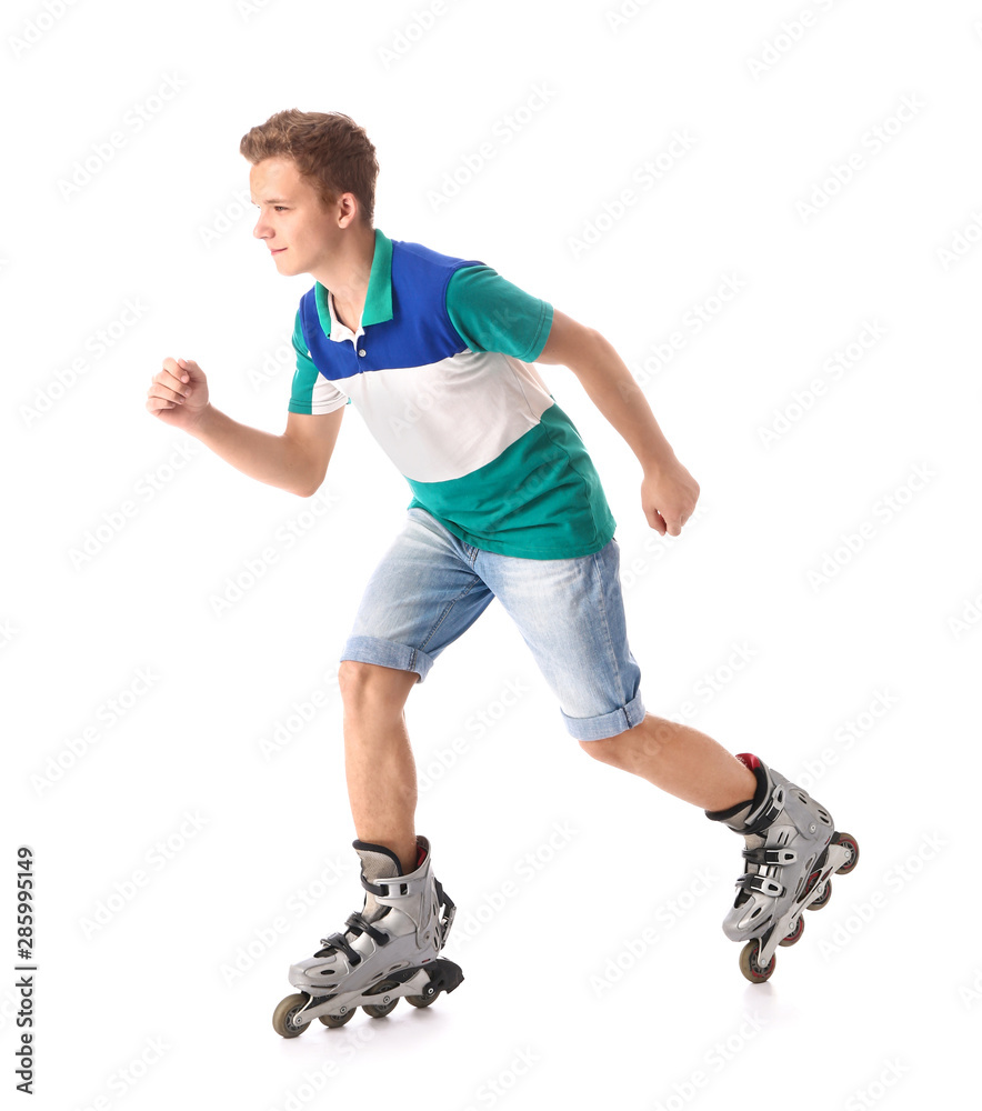 Teenage boy on roller skates against white background