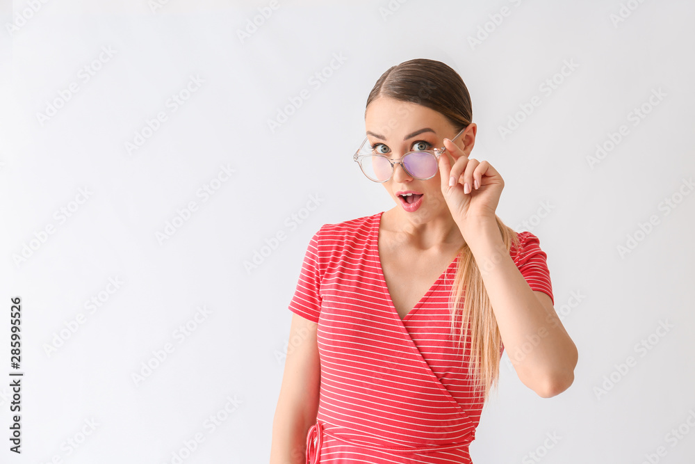 Surprised young woman on white background