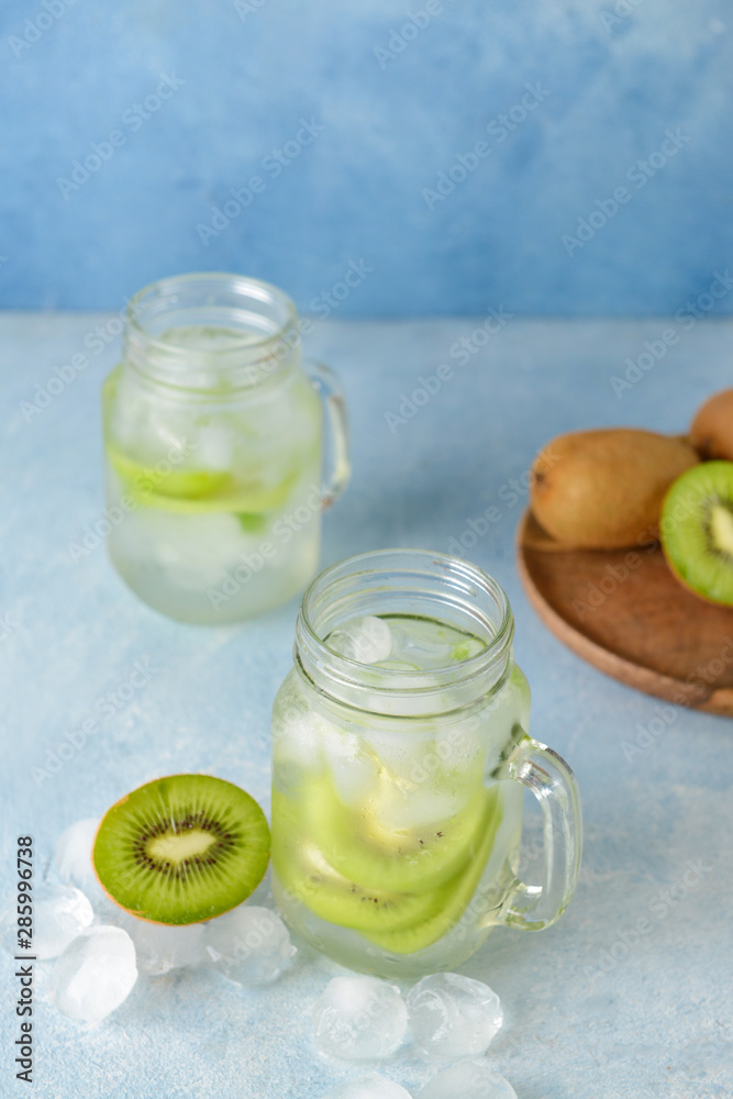 Mason jar of tasty kiwi cocktail on table