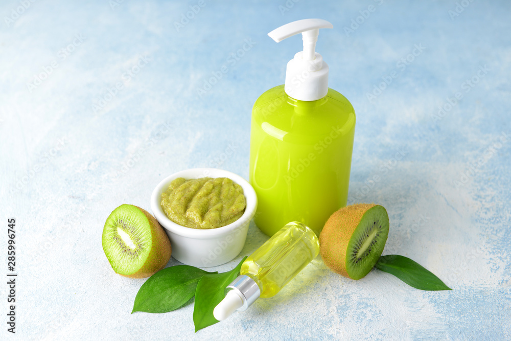 Cosmetics with kiwi on light background