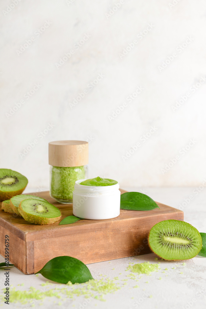 Cosmetics with kiwi on light background