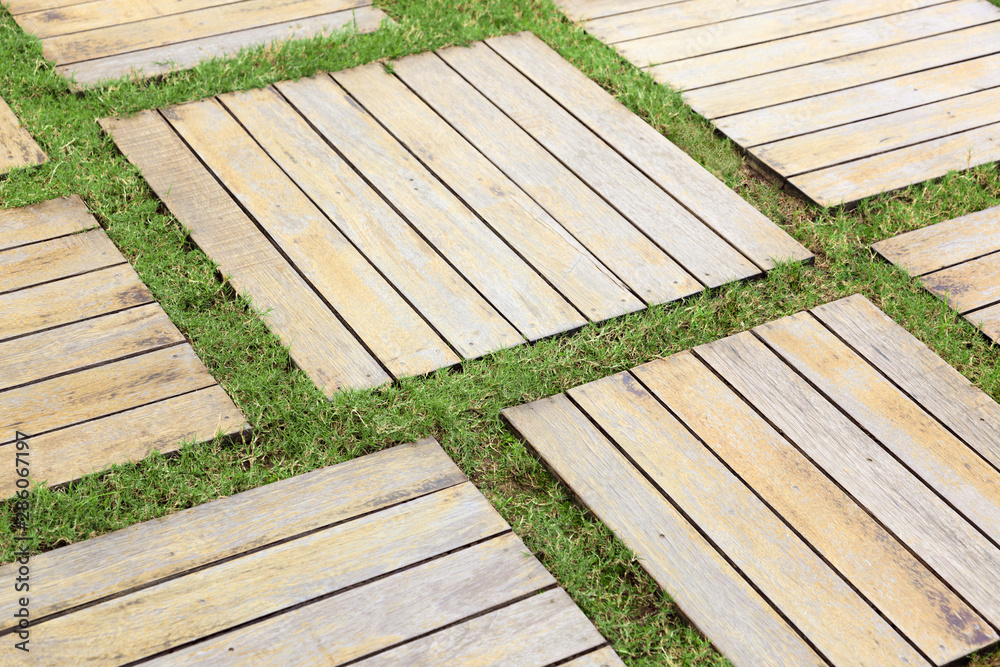 Wooden floor ,outdoors background, small rectangular blocks of wood and grass stripe.