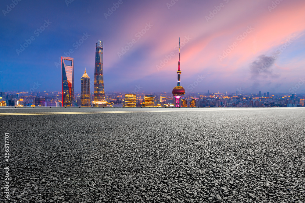 Empty highway and modern city skyline at night in Shanghai,China.