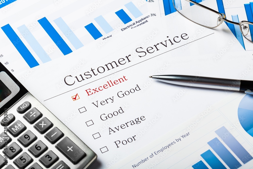 Pen, Calculator and Business Graphs on Questionnaire