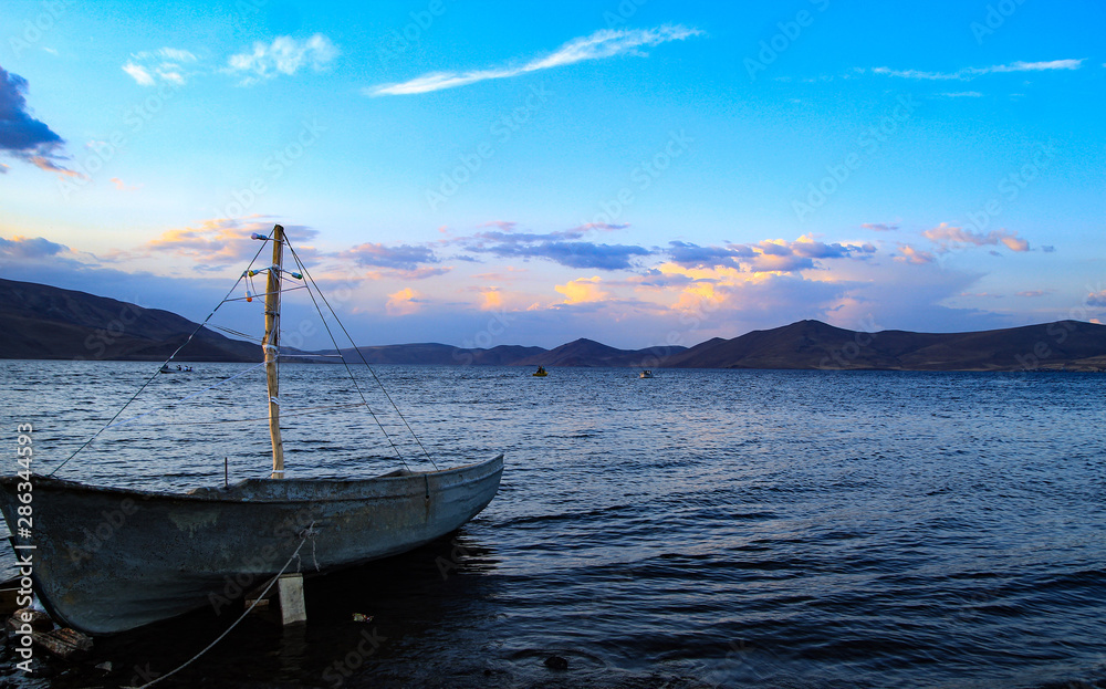 boat in sea at sunset