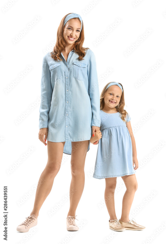 Portrait of beautiful woman with her little daughter on white background