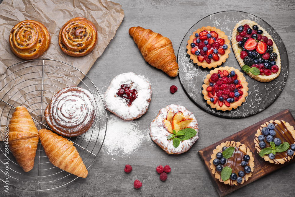 Assortment of sweet pastry on grey background