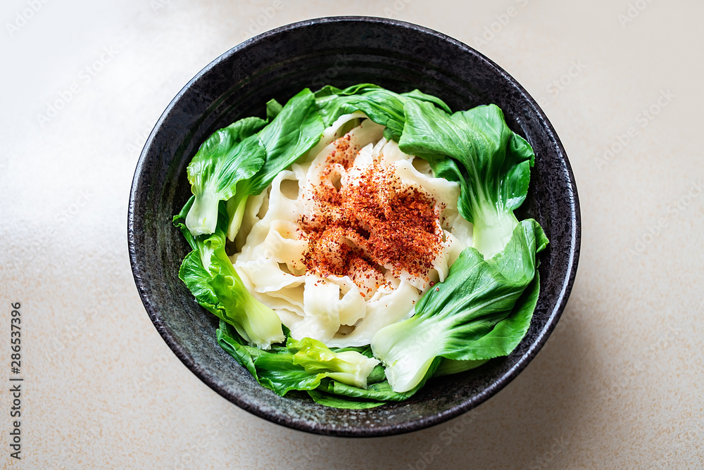 A bowl of nutritious oily noodles on the kitchen countertop