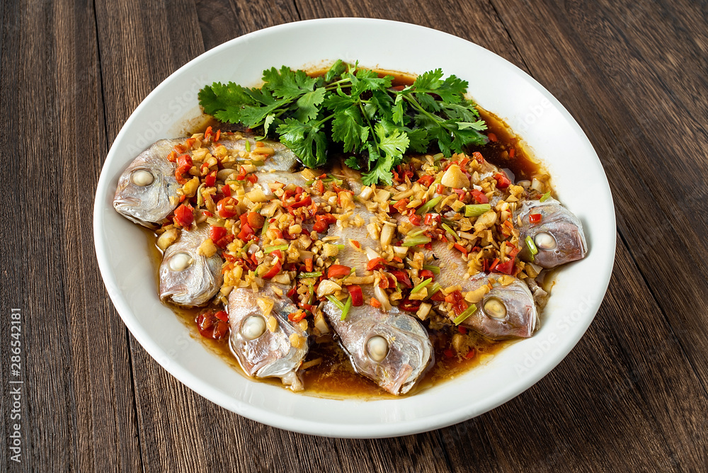 Chinese cuisine chili steamed red squid on wooden board background