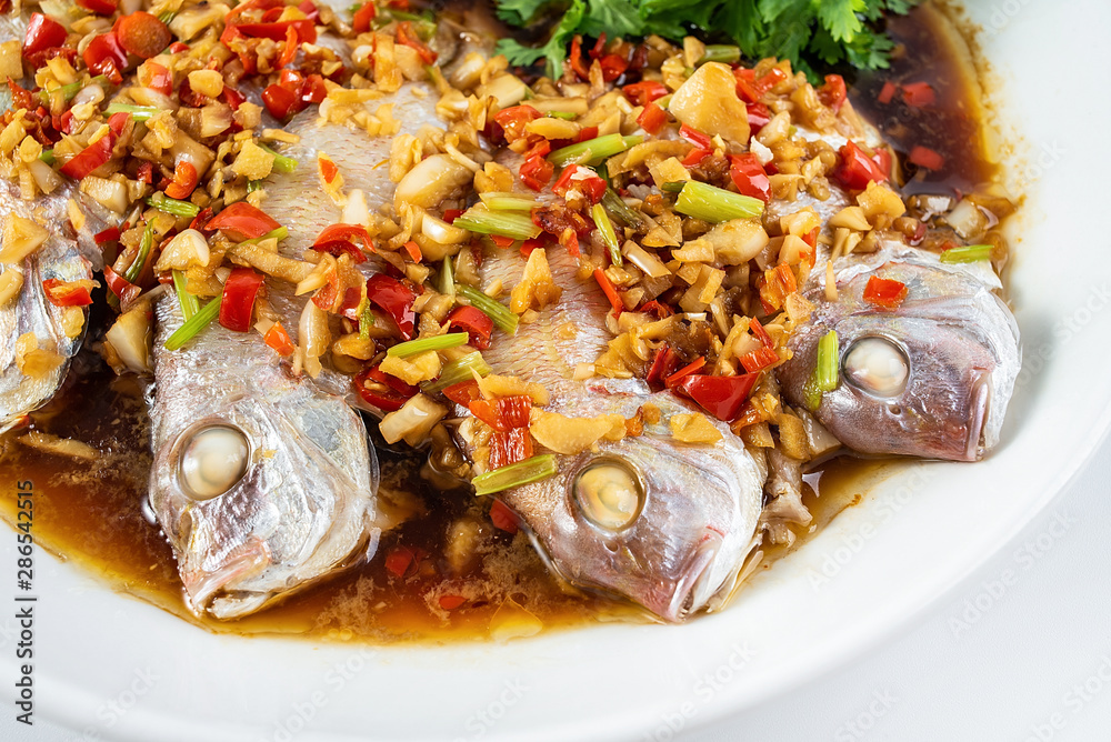 Chinese dish of hot chilli steamed red squid on white background