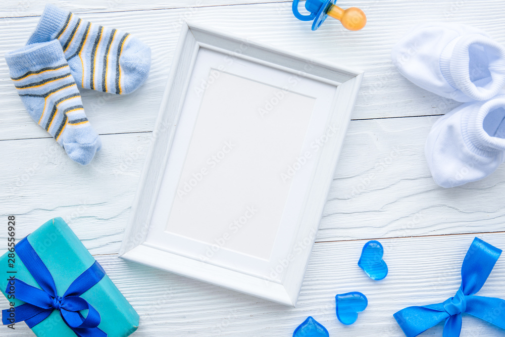 birth of child - blank picture frame on wooden background