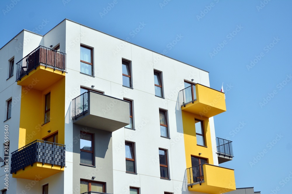 Modern apartment buildings on a sunny day with a blue sky. Facade of a modern apartment building