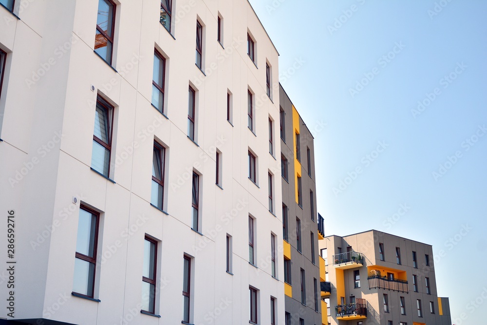 Modern apartment buildings on a sunny day with a blue sky. Facade of a modern apartment building