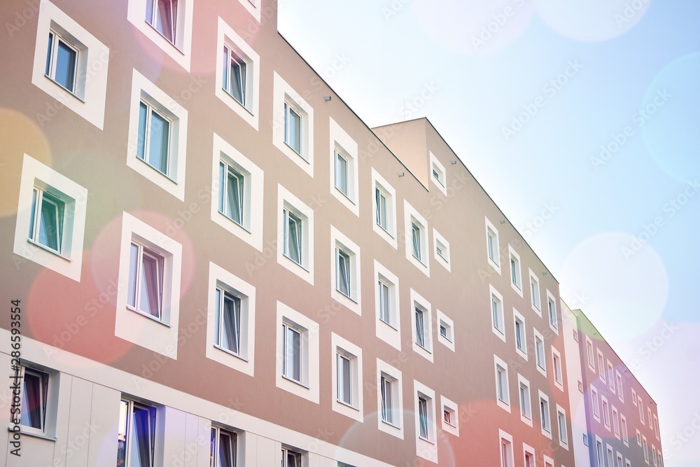 Modern apartment building detail, glass surface with sunlight