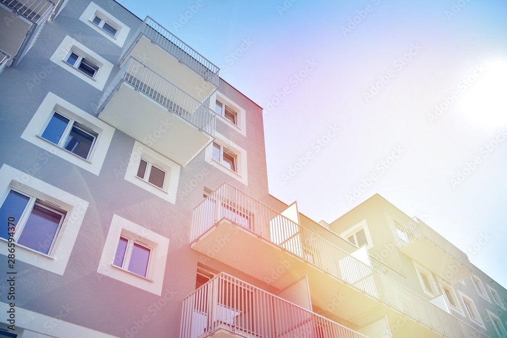 Modern apartment building detail, glass surface with sunlight