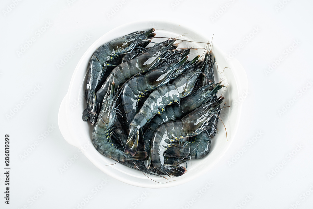 a plate of fresh black prawn on a white background