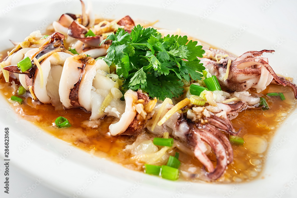 Chinese Cantonese cuisine home cooking, a dish of garlic steamed tubule squid on a white background