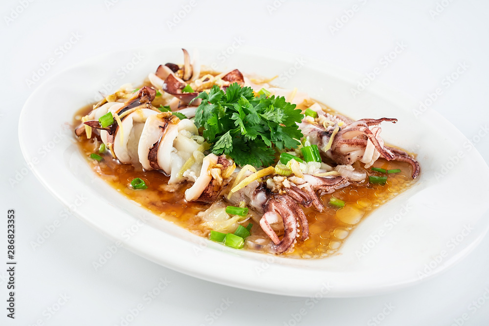 Chinese Cantonese cuisine home cooking, a dish of garlic steamed tubule squid on a white background