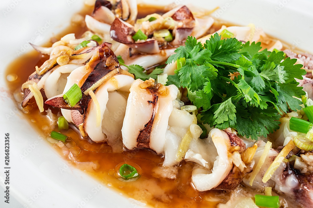 Chinese Cantonese cuisine home cooking, a dish of garlic steamed tubule squid on a white background