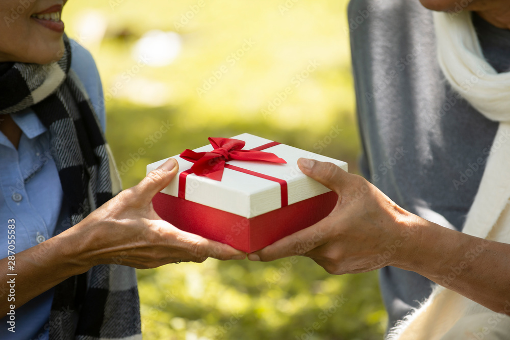 Close up on hands asian Senior couple giving  gift box  to his wife, Retirement Family Lifestyle Hea