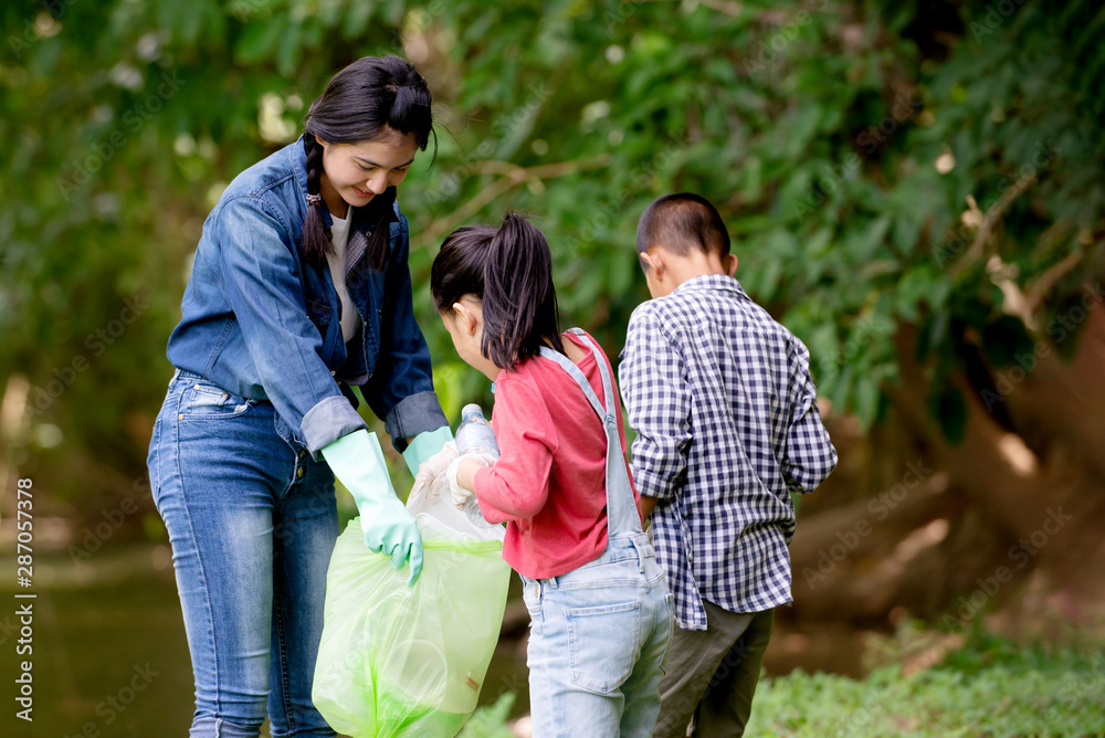 Asian girl with group of kids volunteer charity environment , Ecology cleaning green concept