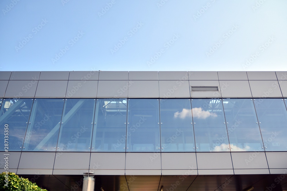 Facade fragment of a modern office building. Exterior of glass wall with abstract texture.