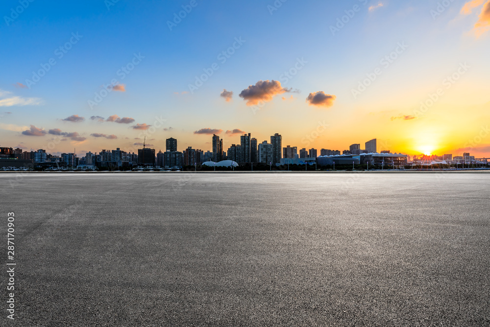 Asphalt race track and city skyline at sunset in Shanghai,China.