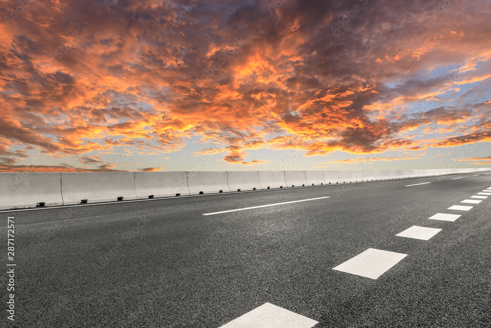 Empty asphalt highway and beautiful sky clouds at sunset